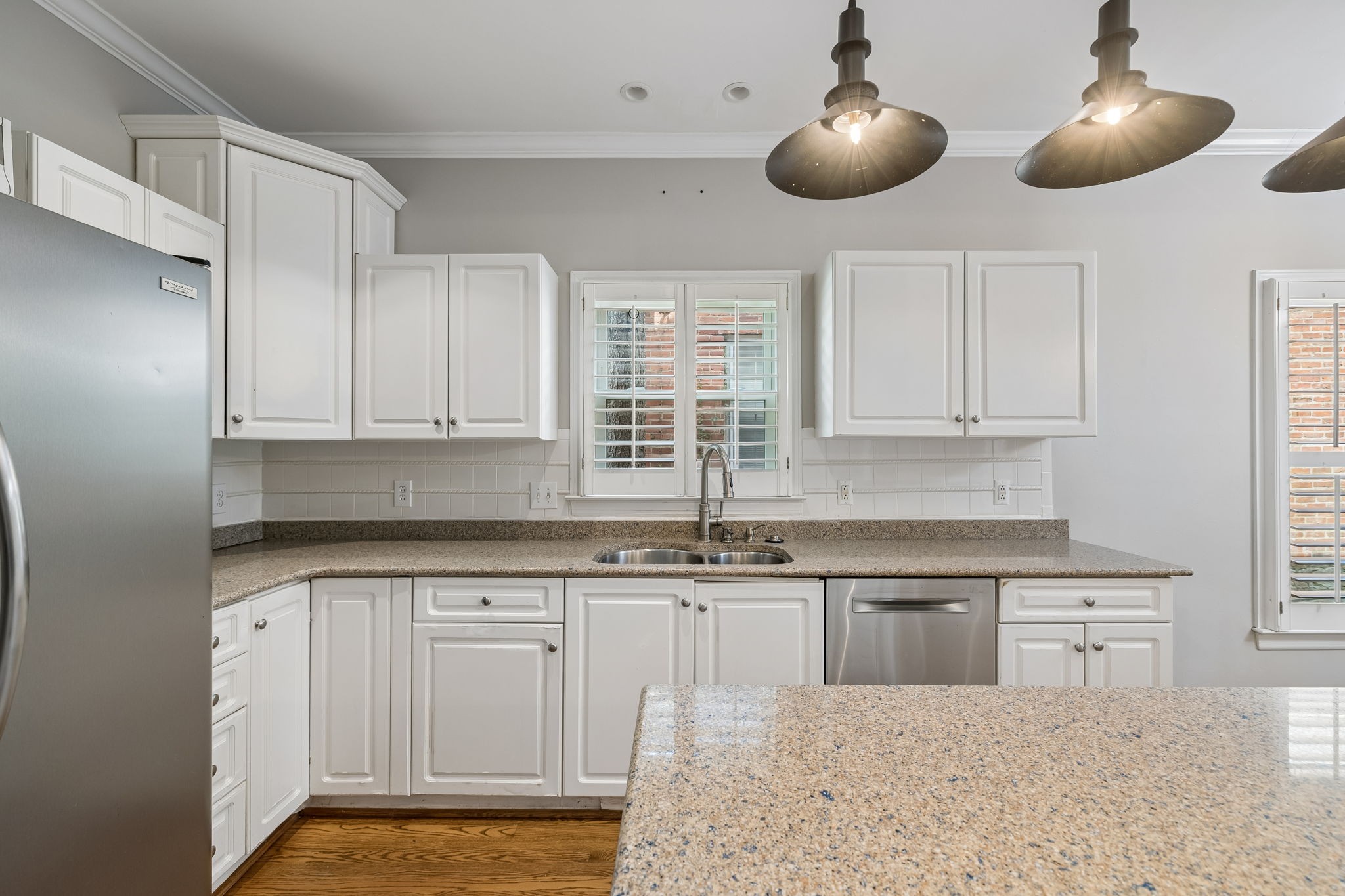 230 Harding Place Nashville, TN 37205 - Photo 20 of 54 a kitchen with white cabinets and chandelier