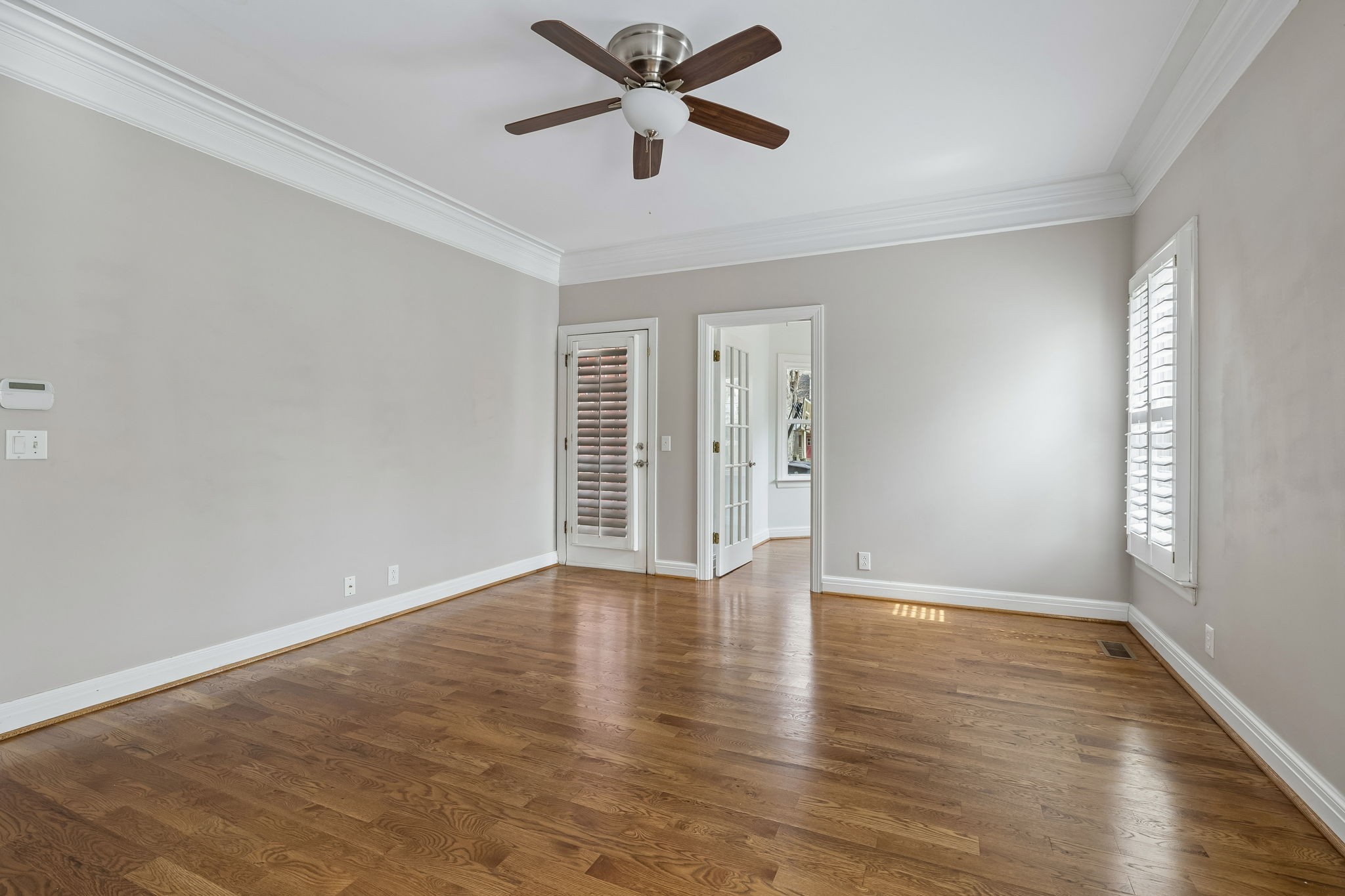 230 Harding Place Nashville, TN 37205 - Photo 26 of 54 an empty room with wooden floor fan and windows