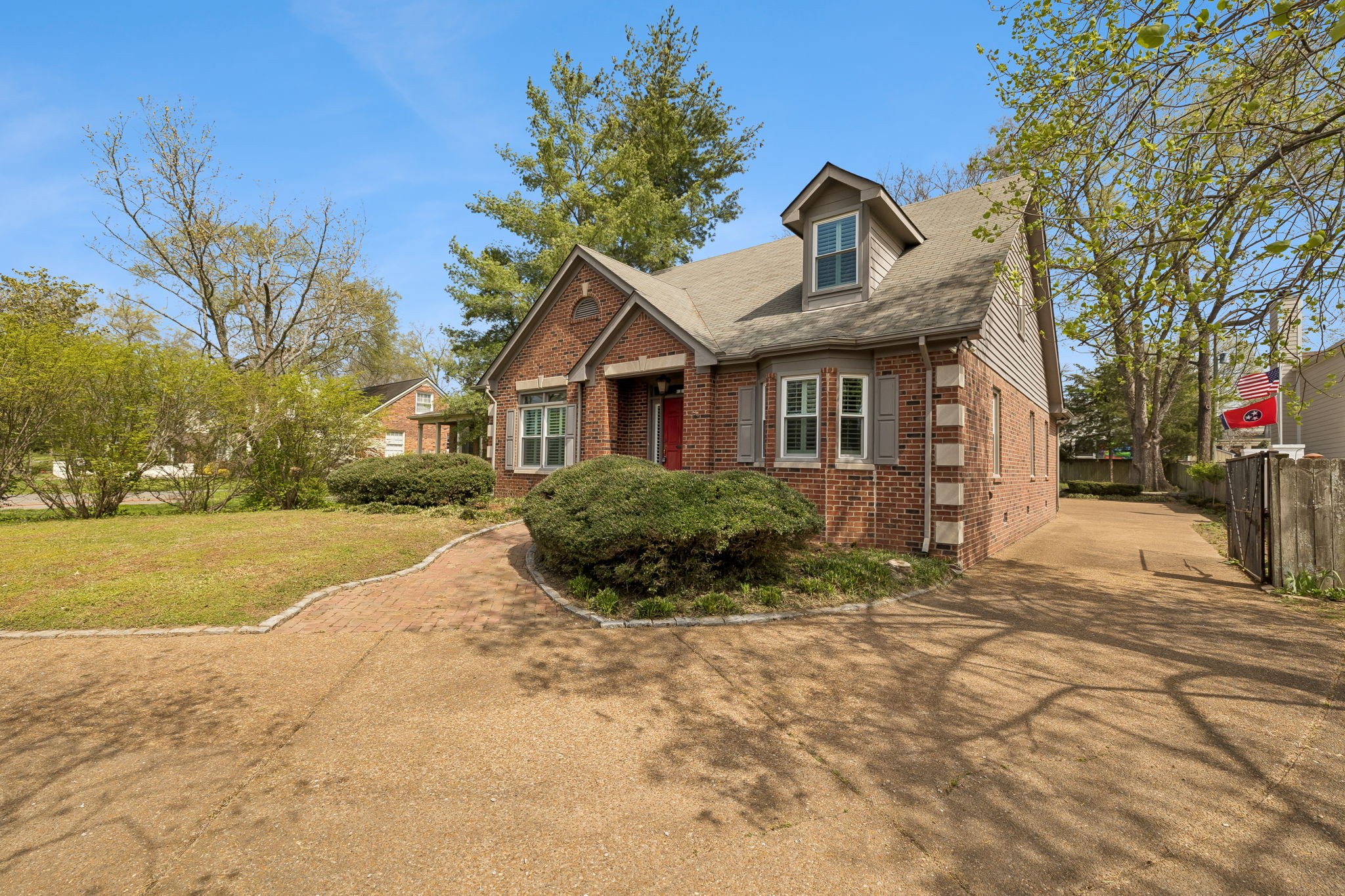 230 Harding Place Nashville, TN 37205 - Photo 3 of 54 a front view of a house with a yard and garage