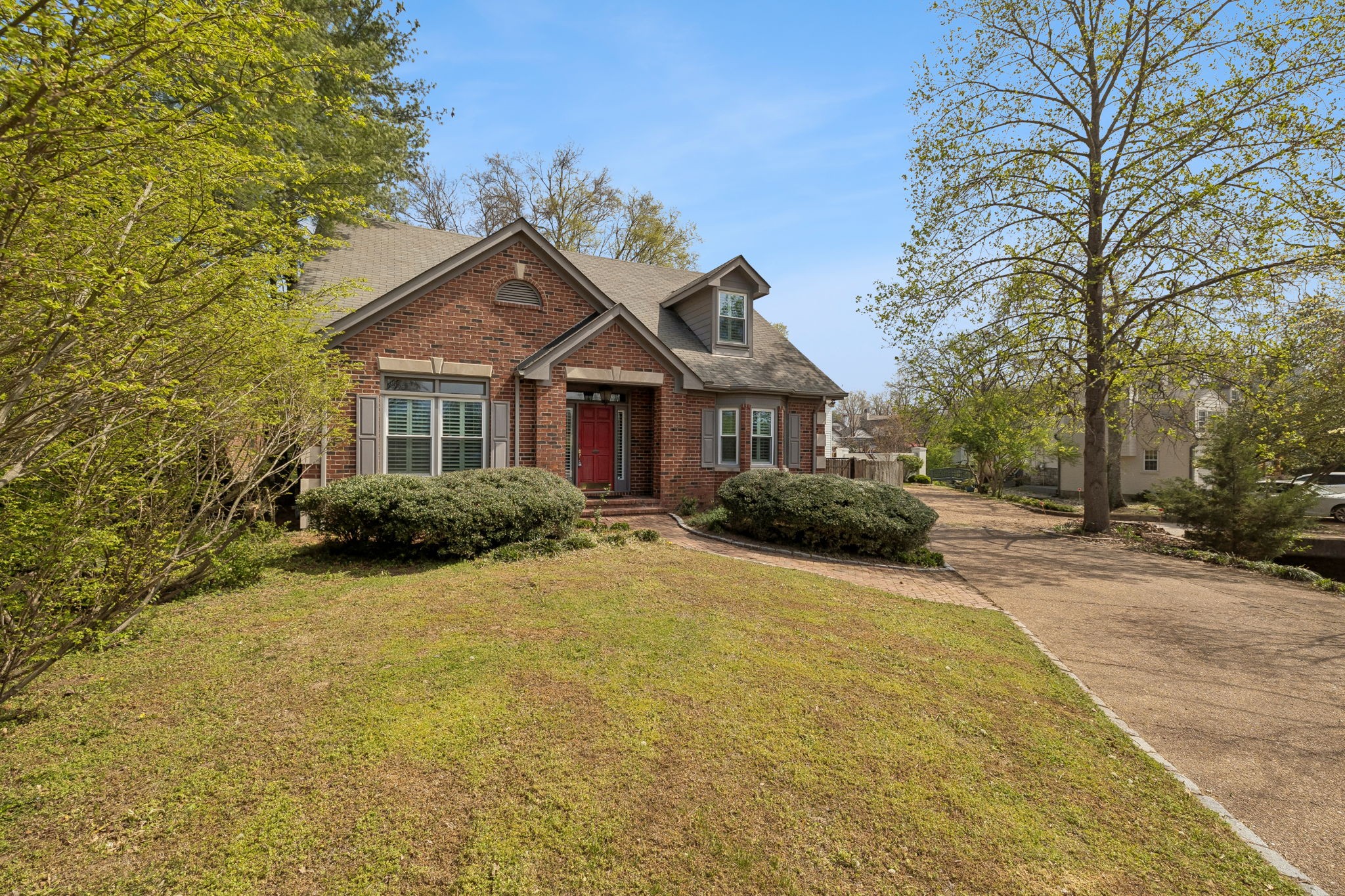 230 Harding Place Nashville, TN 37205 - Photo 5 of 54 a front view of a house with a garden