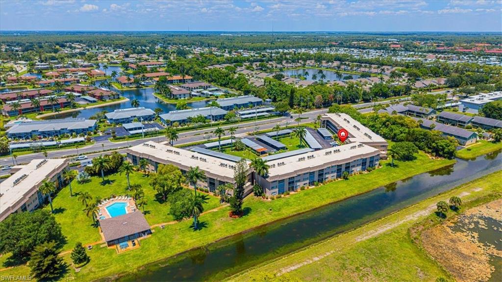 5483 Rattlesnake Hammock Road, Unit B201 Naples, FL 34113 - Photo 2 of 22 an aerial view of residential houses with outdoor space and swimming pool