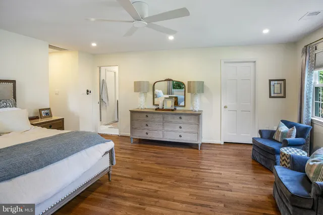 a spacious bedroom with a bed and a couch