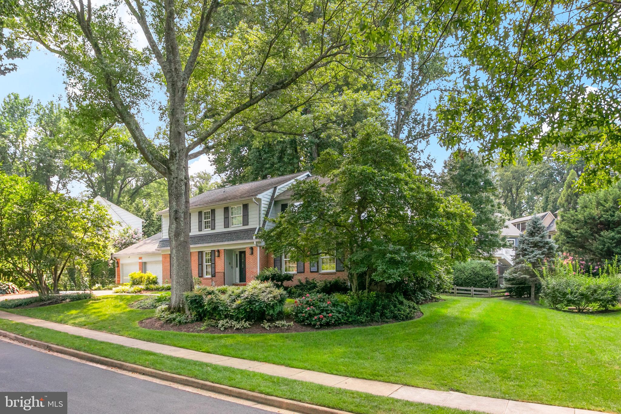 1212 Old Stable Road McLean, VA 22102 - Photo 32 of 33 a view of a brick building next to a yard with big trees
