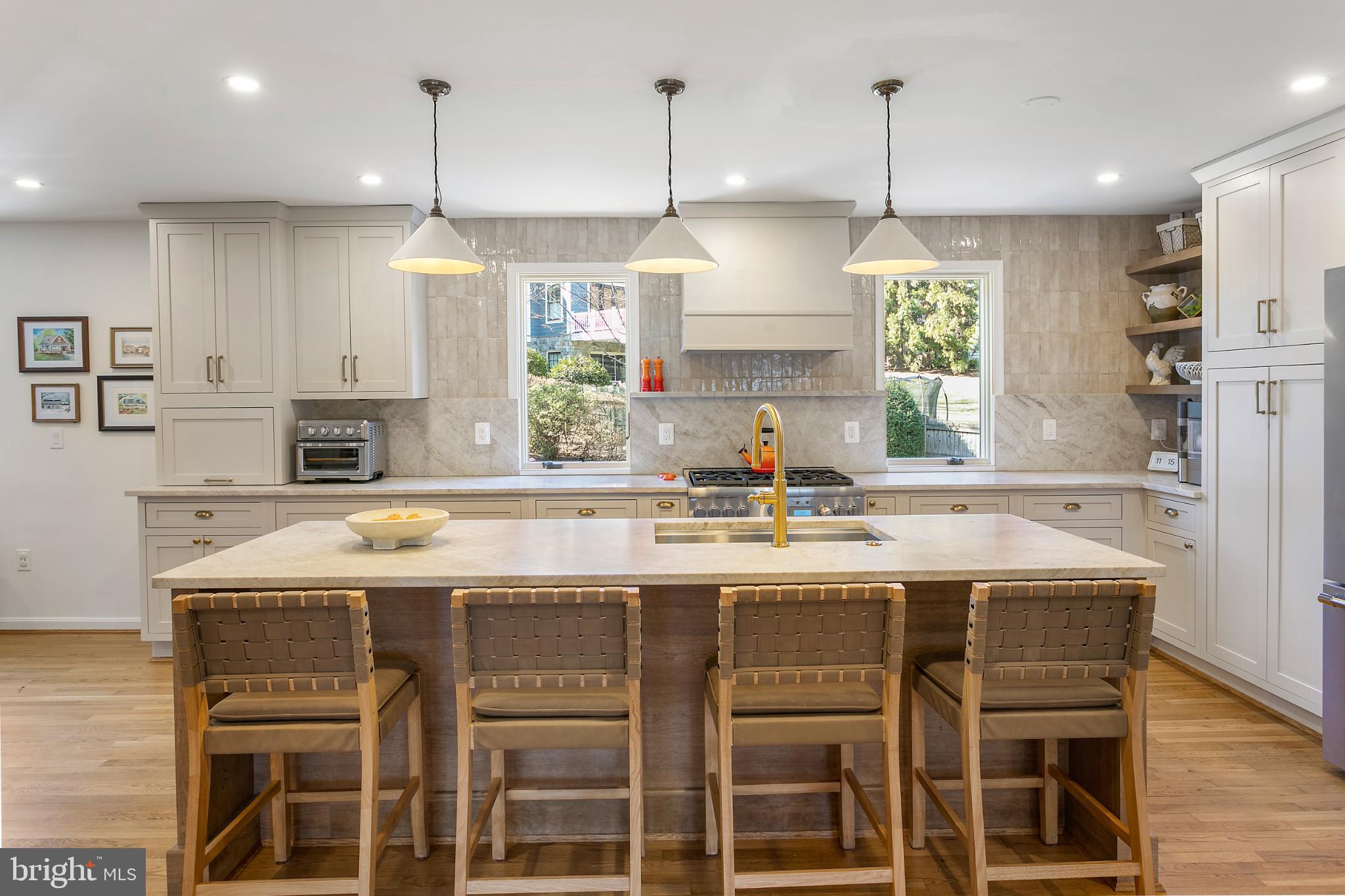 1212 Old Stable Road McLean, VA 22102 - Photo 6 of 33 a kitchen with stainless steel appliances granite countertop a sink a stove and a wooden floors