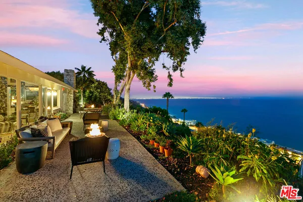 a view of a chairs and table in the patio