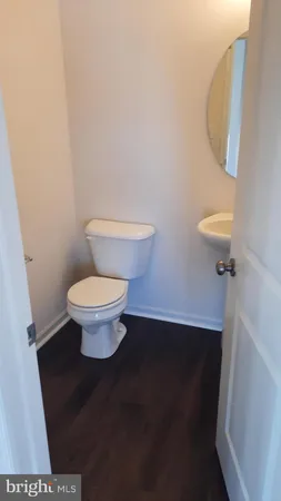 a toilet sitting in a bathroom next to a sink