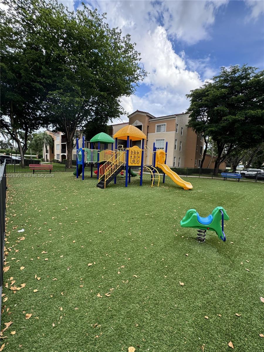 2021 Renaissance Boulevard, Unit 201 Miramar, FL 33025 - Photo 26 of 26 a childrens park with lots of swings and slides