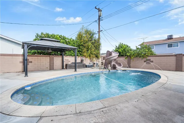 an aerial view of a house with a yard and a fountain