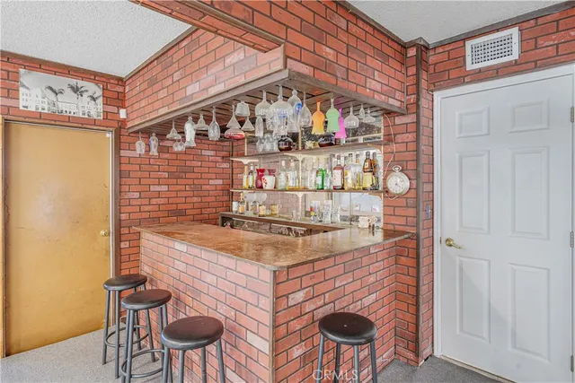 an aerial view of residential houses with outdoor space and parking