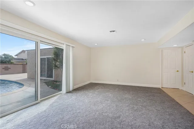 an empty room with sliding glass door