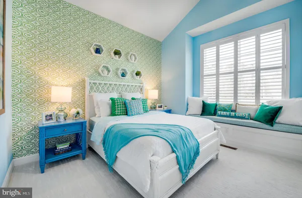 a bedroom with a bed mirror and a large window