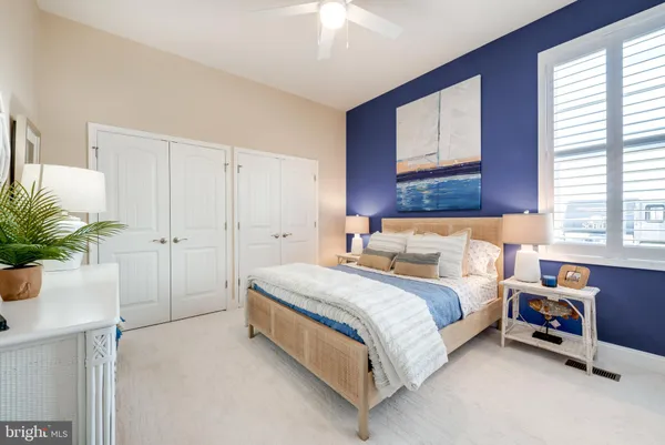 a bed room with a bed and a potted plant