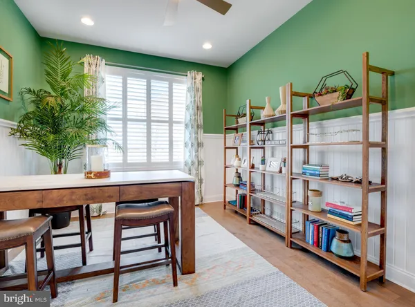a room with lots of wooden furniture and a book shelf