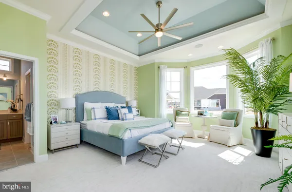 a bedroom with furniture and a large window