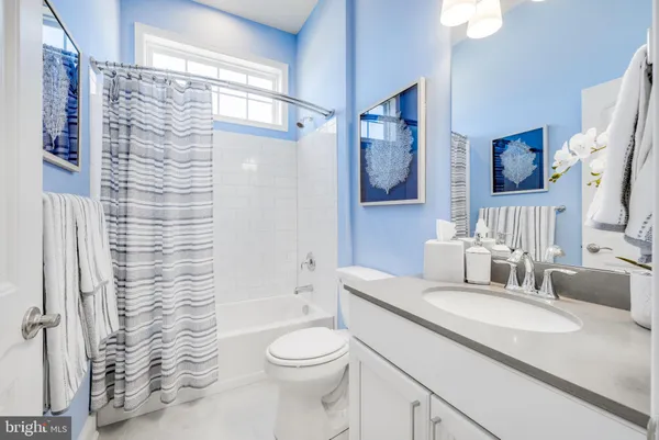 a spacious bathroom with a granite countertop sink mirror and shower