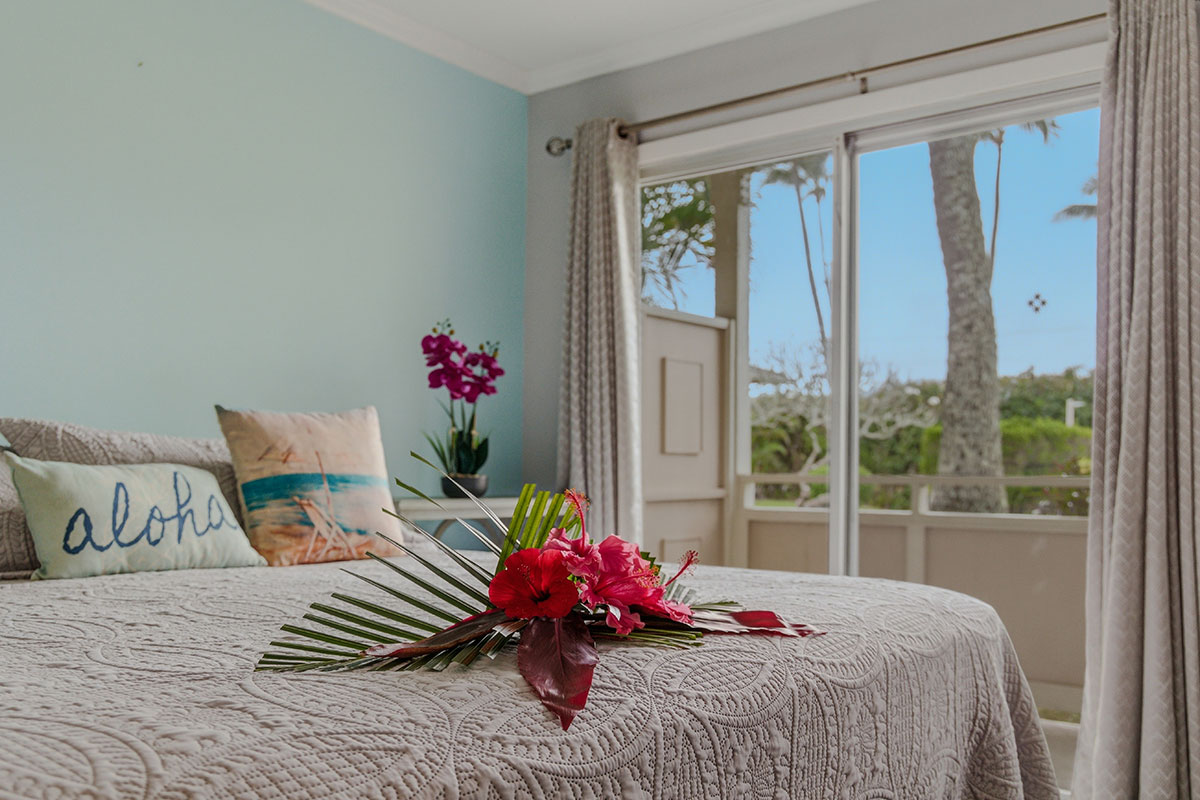 525 Aleka Loop, Unit J2 Kapaa, HI 96746 - Photo 14 of 30 a bedroom with a bed and wooden floor