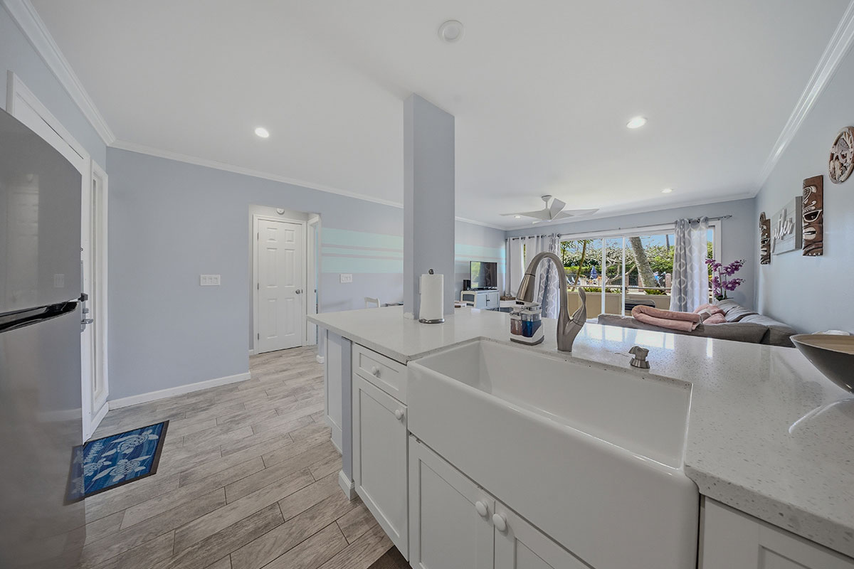525 Aleka Loop, Unit J2 Kapaa, HI 96746 - Photo 5 of 30 a view of a kitchen with kitchen island a sink appliances wooden floor and a counter top space