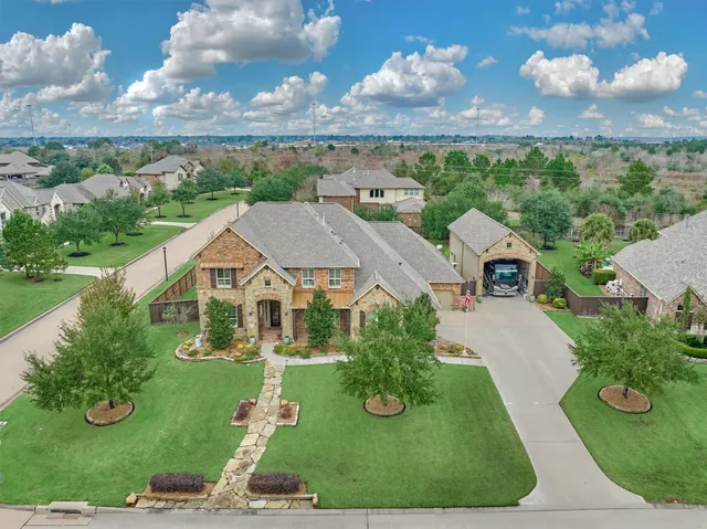 an aerial view of a house with a garden and trees