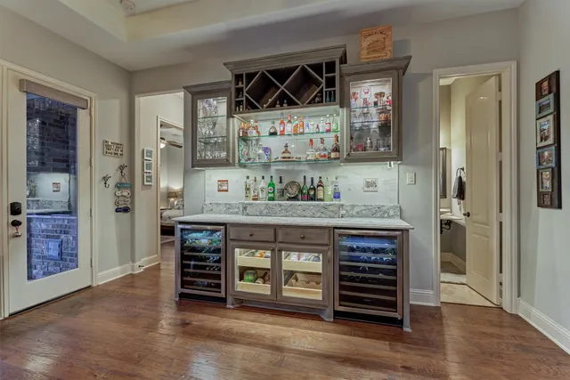 a en suite bathroom with a granite countertop sink and a mirror