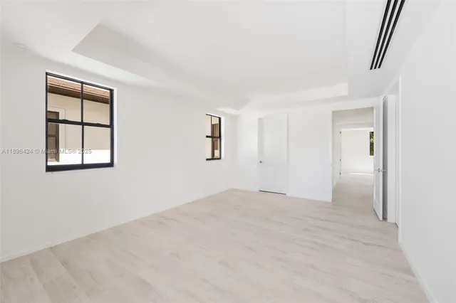 an empty room with windows and closet