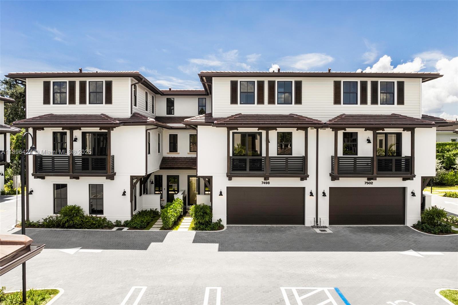 7498 Southwest 100th Street, Unit 8 Pinecrest, FL 33156 - Photo 2 of 61 a front view of a building with a yard