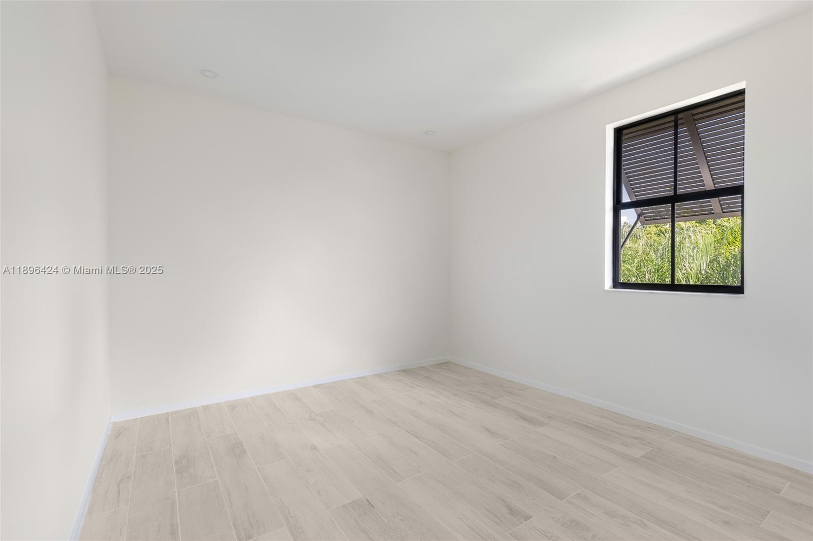 7498 Southwest 100th Street, Unit 8 Pinecrest, FL 33156 - Photo 28 of 61 an empty room with a window