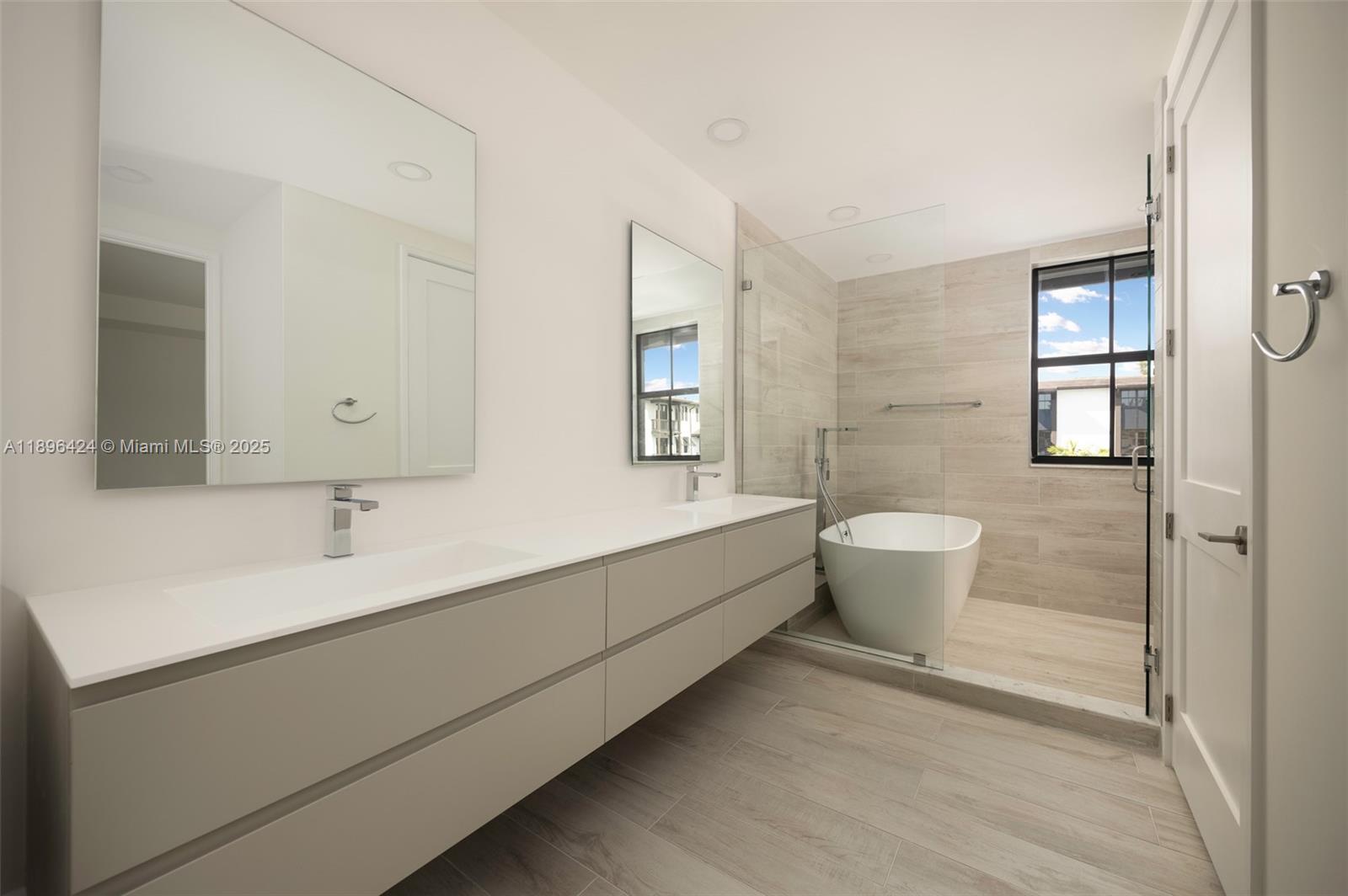 7498 Southwest 100th Street, Unit 8 Pinecrest, FL 33156 - Photo 31 of 61 a bathroom with a sink and a mirror