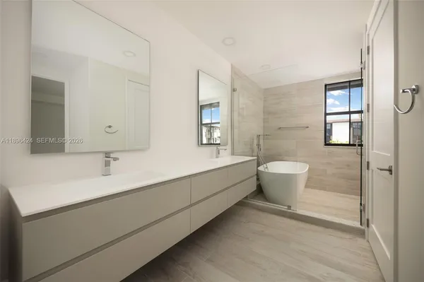 a bathroom with a granite countertop sink a toilet and shower