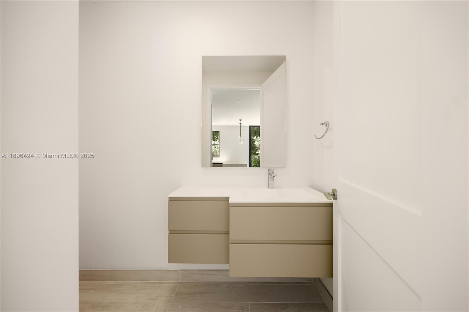 7498 Southwest 100th Street, Unit 8 Pinecrest, FL 33156 - Photo 34 of 61 a bathroom with a sink and a mirror