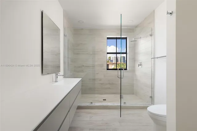 a bathroom with a toilet and a shower