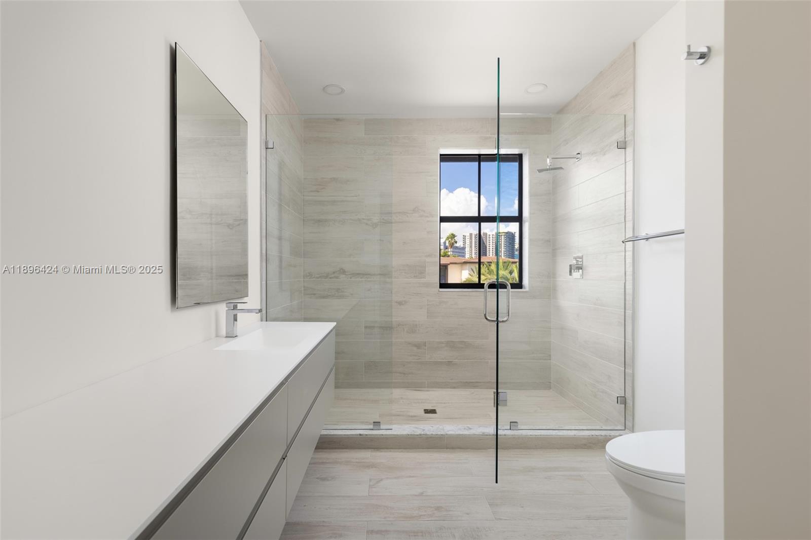 7498 Southwest 100th Street, Unit 8 Pinecrest, FL 33156 - Photo 35 of 61 a bathroom with a granite countertop sink a toilet and shower