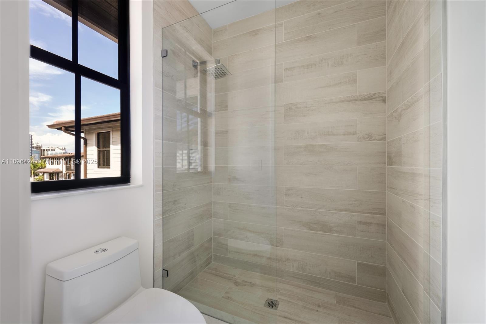 7498 Southwest 100th Street, Unit 8 Pinecrest, FL 33156 - Photo 37 of 61 a bathroom with a toilet and a shower