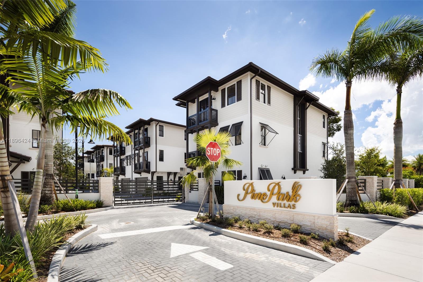 7498 Southwest 100th Street, Unit 8 Pinecrest, FL 33156 - Photo 41 of 61 a front view of multi story residential apartment building with yard and sign board
