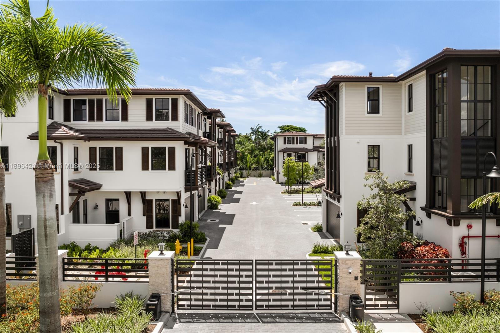 7498 Southwest 100th Street, Unit 8 Pinecrest, FL 33156 - Photo 43 of 61 a front view of a house with a garden