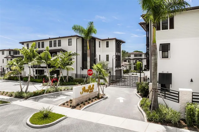 an aerial view of multiple houses with yard