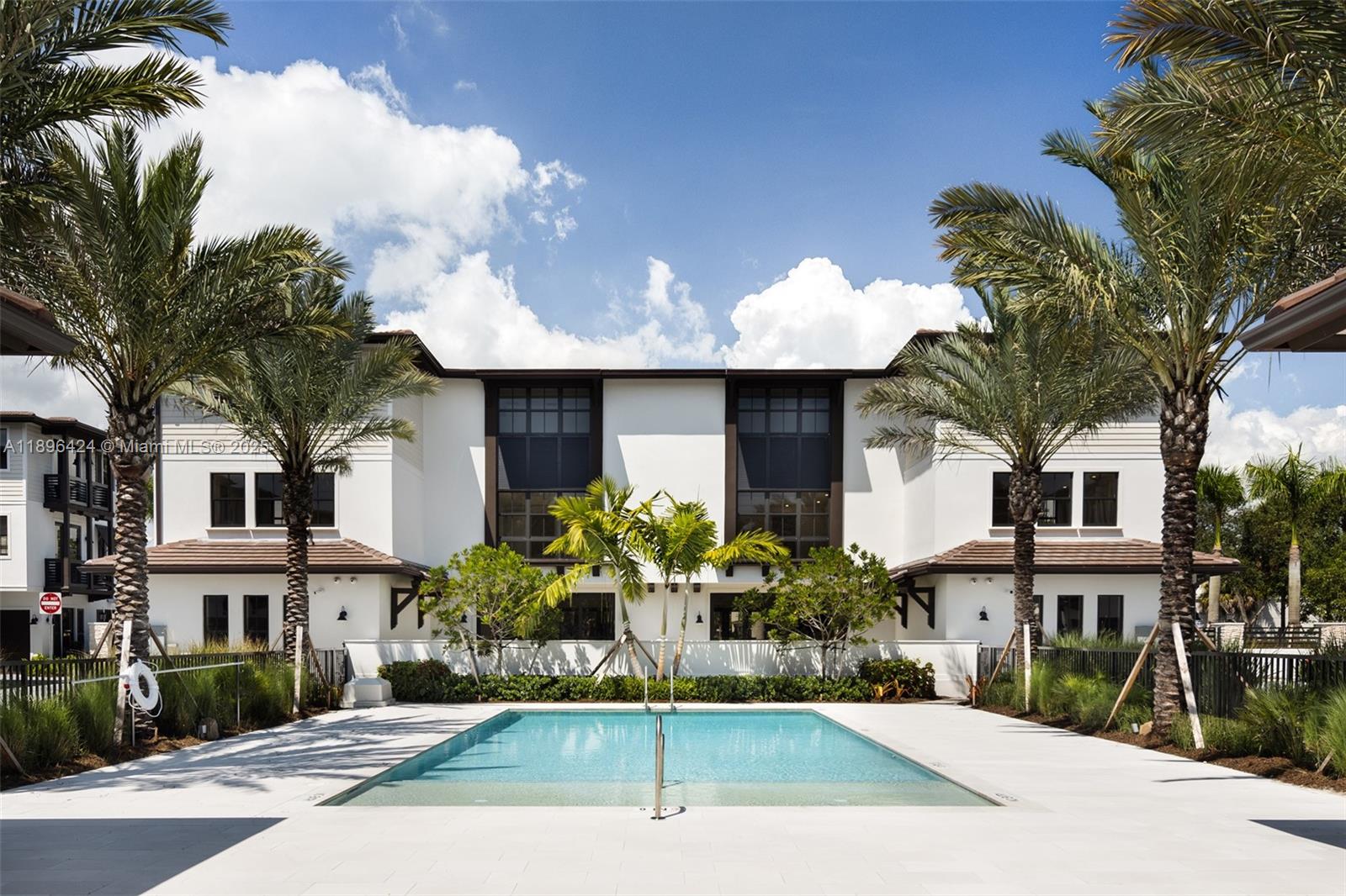 7498 Southwest 100th Street, Unit 8 Pinecrest, FL 33156 - Photo 46 of 61 a front view of a house with a garden