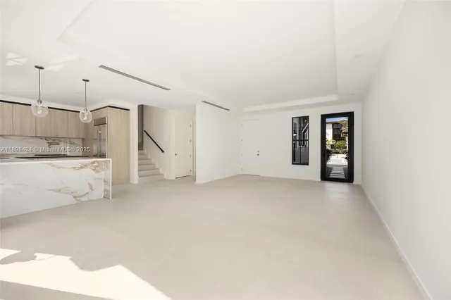 a view of a kitchen with refrigerator and more cabinets