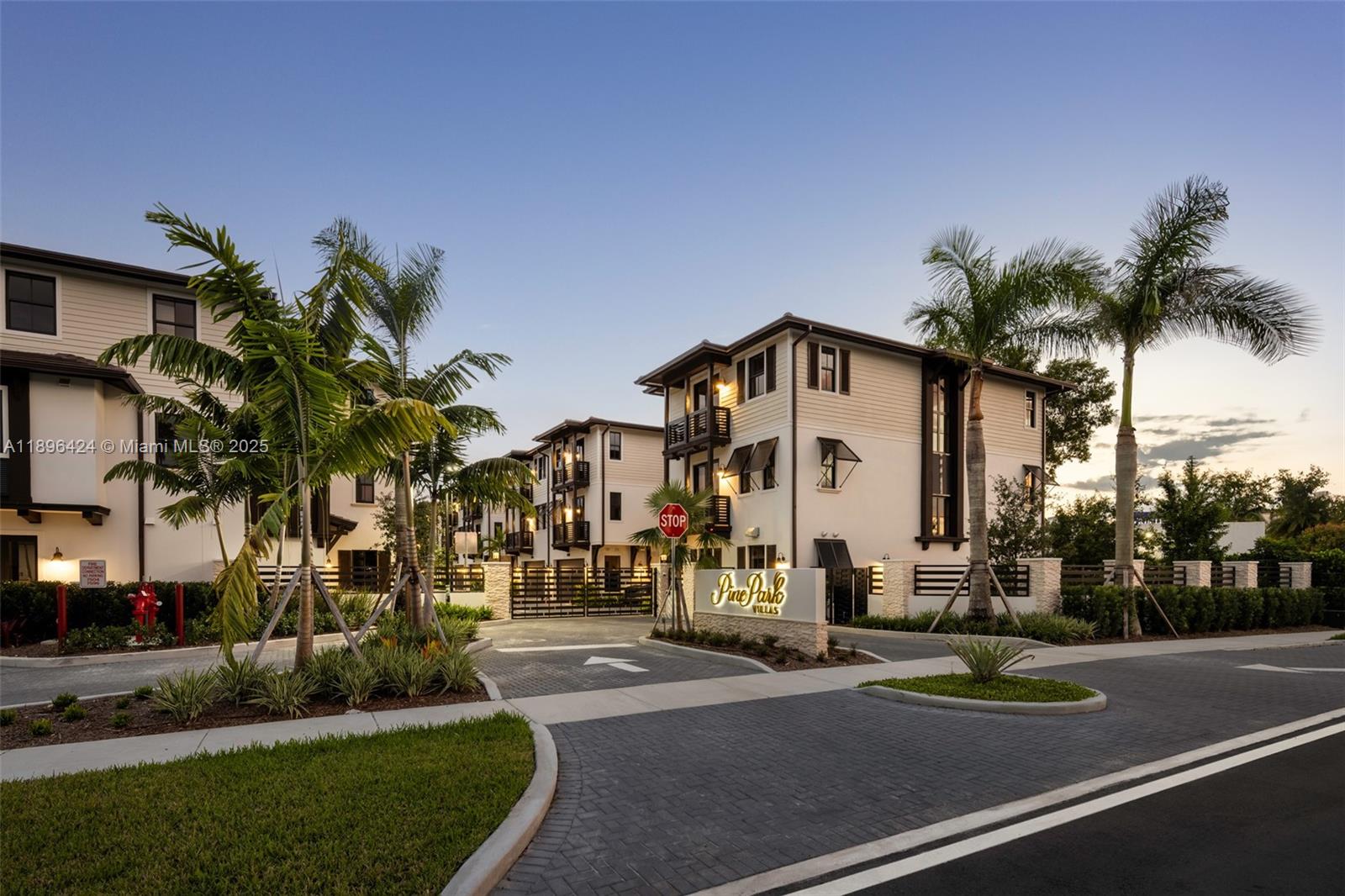 7498 Southwest 100th Street, Unit 8 Pinecrest, FL 33156 - Photo 57 of 61 a view of a white building among the street with palm trees