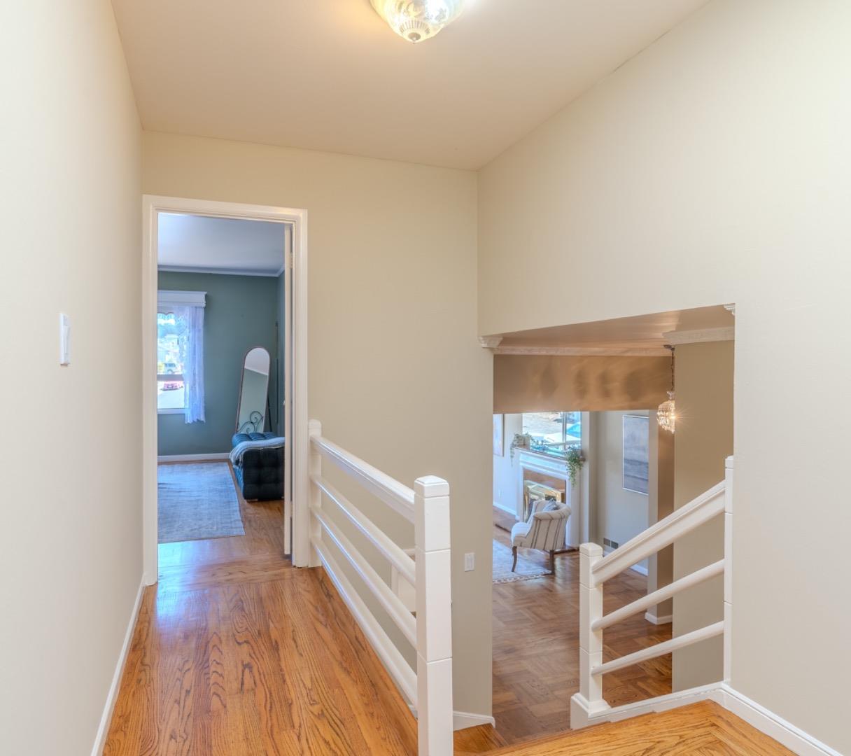67 Cliffside Drive Daly City, CA 94015 - Photo 16 of 37 a view of a hallway with wooden floor and staircase