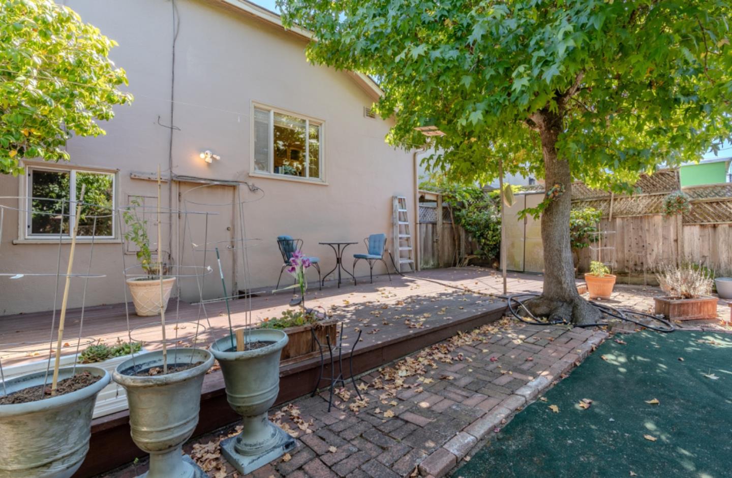 67 Cliffside Drive Daly City, CA 94015 - Photo 27 of 37 a view of a backyard with table and chairs potted plants and large tree