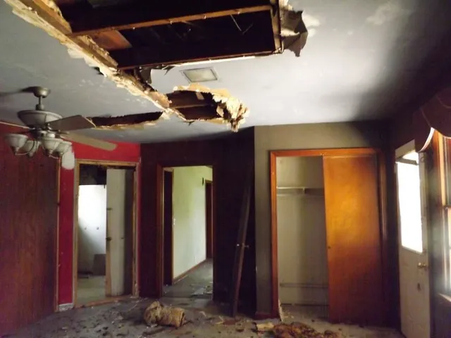 a view of a hallway with wooden walls