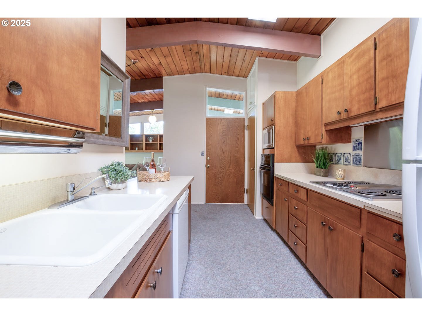 1439 Barton Street Eugene, OR 97404 - Photo 17 of 30 a kitchen with a sink a refrigerator and cabinets