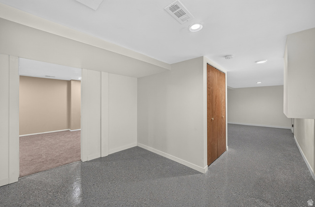 4468 North Droubay Road Tooele, UT 84074 - Photo 34 of 60 Recessed lighting illuminates the space, featuring a wood-finish bi-fold closet door and durable epoxy flooring