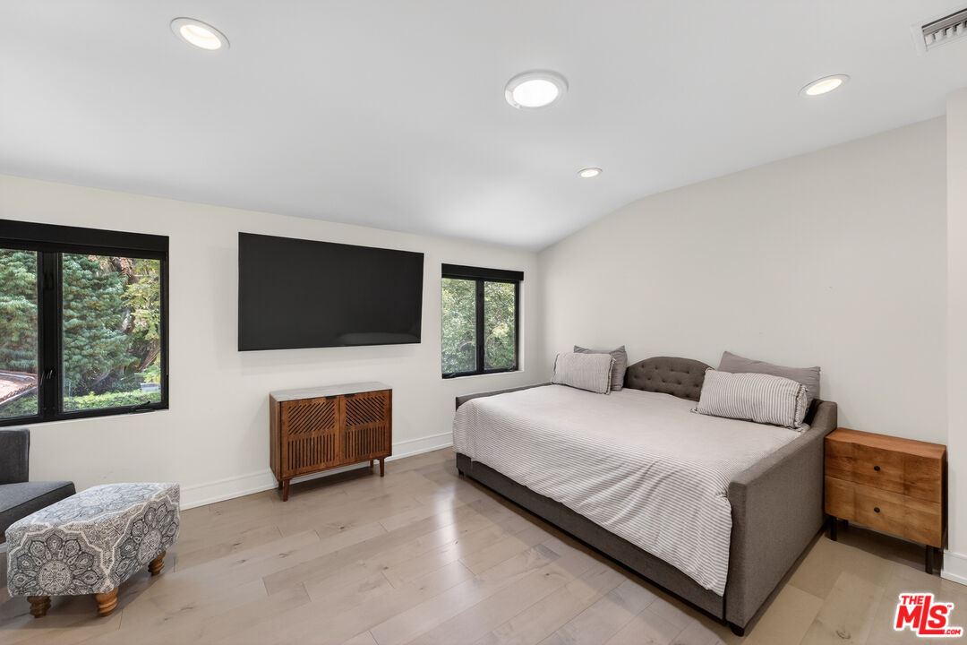 760 South San Rafael Avenue Pasadena, CA 91105 - Photo 36 of 45 a bedroom with a bed and a flat screen tv