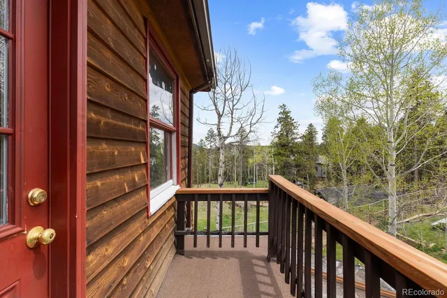 a view of a balcony with trees