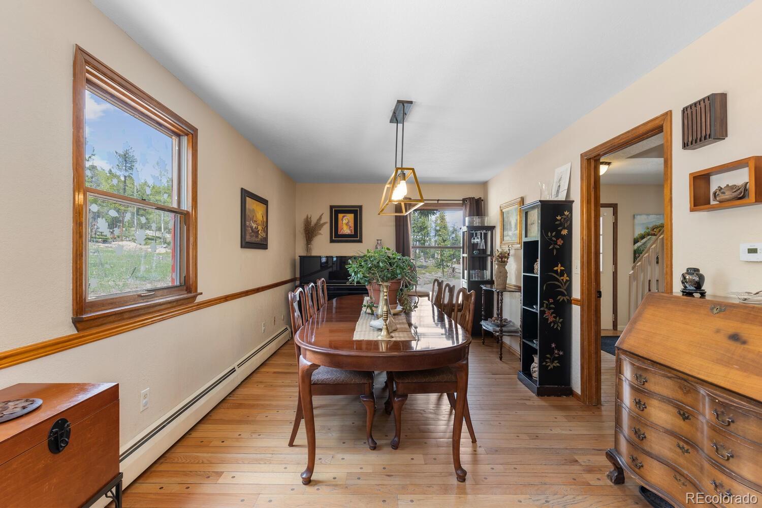 8600 South Warhawk Road Conifer, CO 80433 - Photo 16 of 50 a view of a dining room with furniture window and wooden floor