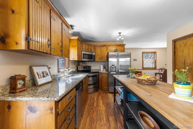 a kitchen with granite countertop lots of counter top space and stainless steel appliances