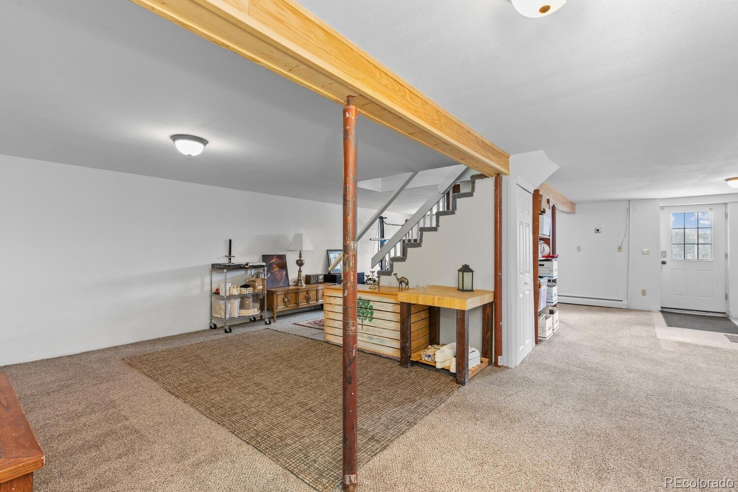 8600 South Warhawk Road Conifer, CO 80433 - Photo 26 of 50 a view of a livingroom with stairs and furniture
