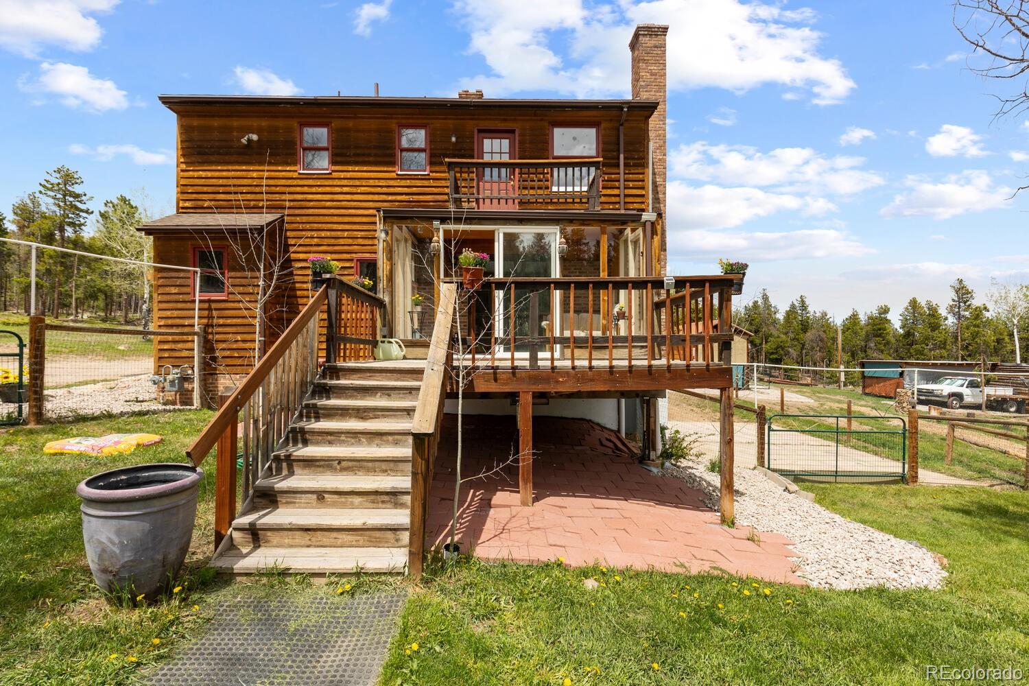8600 South Warhawk Road Conifer, CO 80433 - Photo 31 of 50 a view of a house with backyard and deck