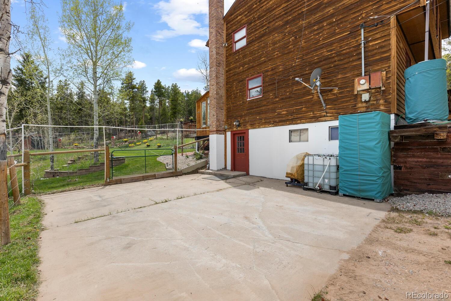 8600 South Warhawk Road Conifer, CO 80433 - Photo 32 of 50 a view of a house with backyard and a trees